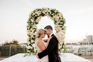 Luxurious White Rose, Hydrangeas, and Greenery Wedding Ceremony Arch with White Stage Ideas