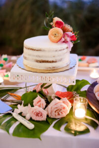 Single Tier Naked White Round Wedding Cake With Tropical Pink, Red, and Orange Flowers