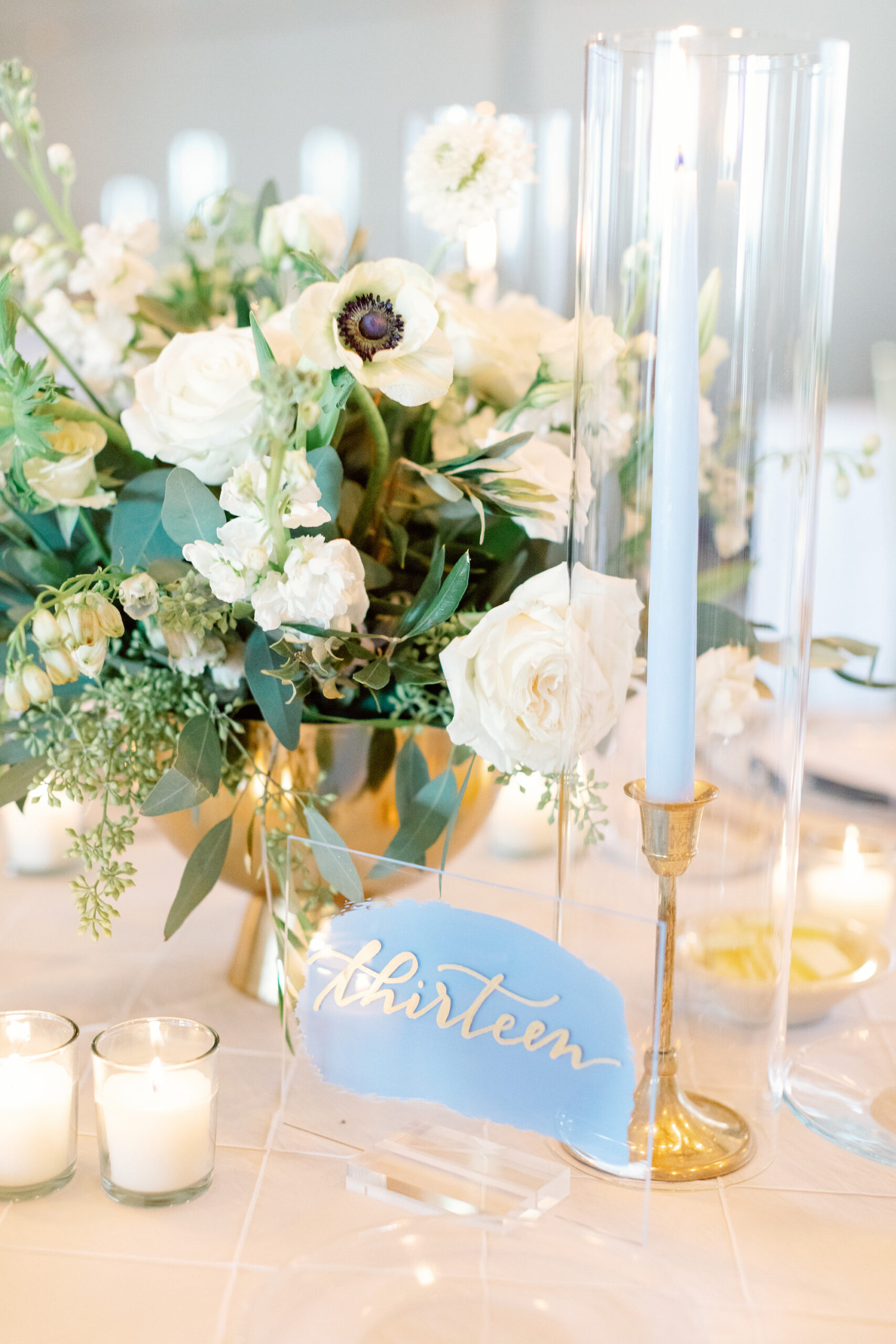 Blue Taper Candle with Painted Acrylic Wedding Reception Name Place Cards and Gold Decor with White Centerpieces | Elegant Reception Inspiration | Florist Botanica International Design Studio