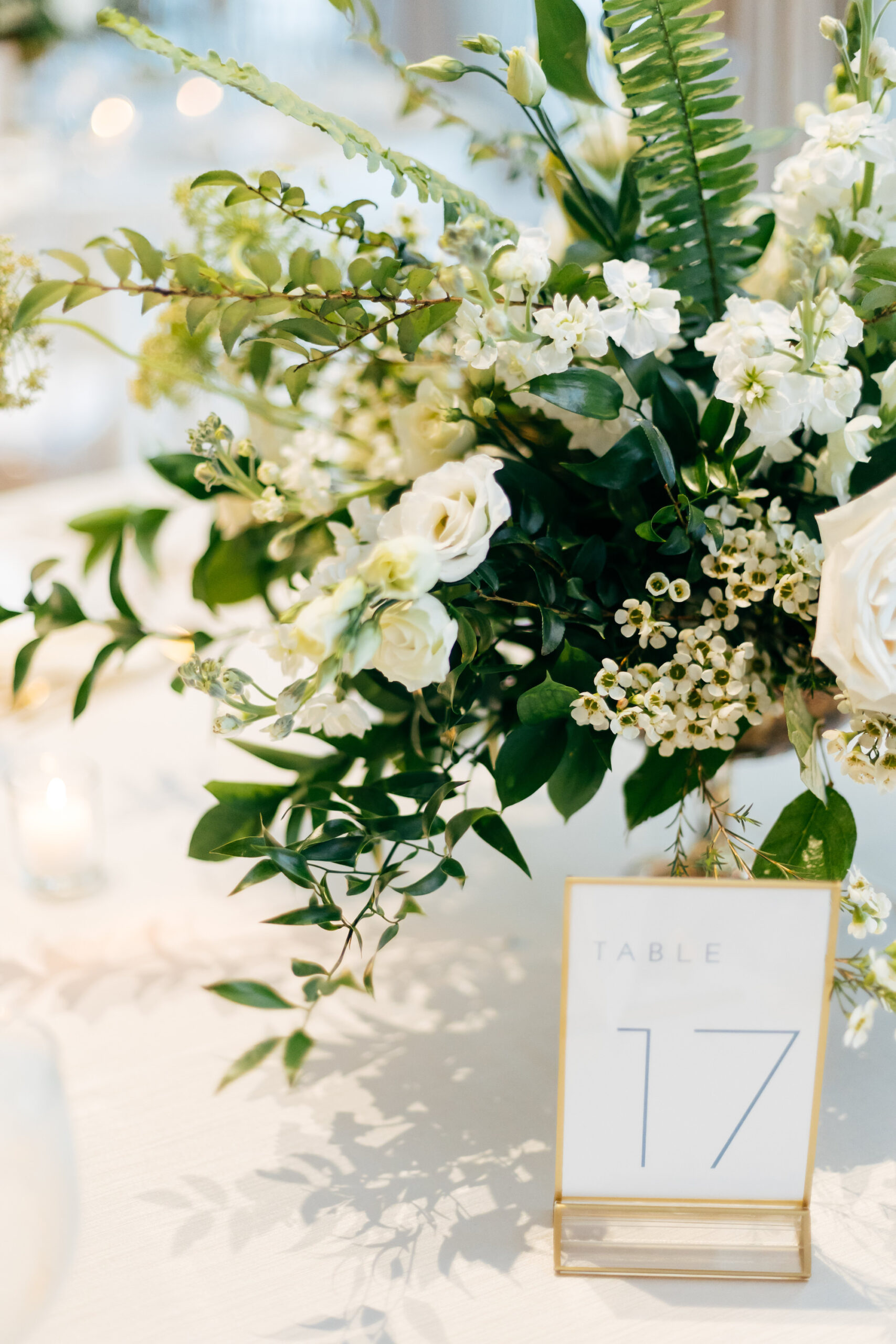 Modern Gold Frame Table Number, Floral Centerpiece with Greenery, White Roses, Cream Flowers | Tampa Bay Wedding Florist Bruce Wayne Florals