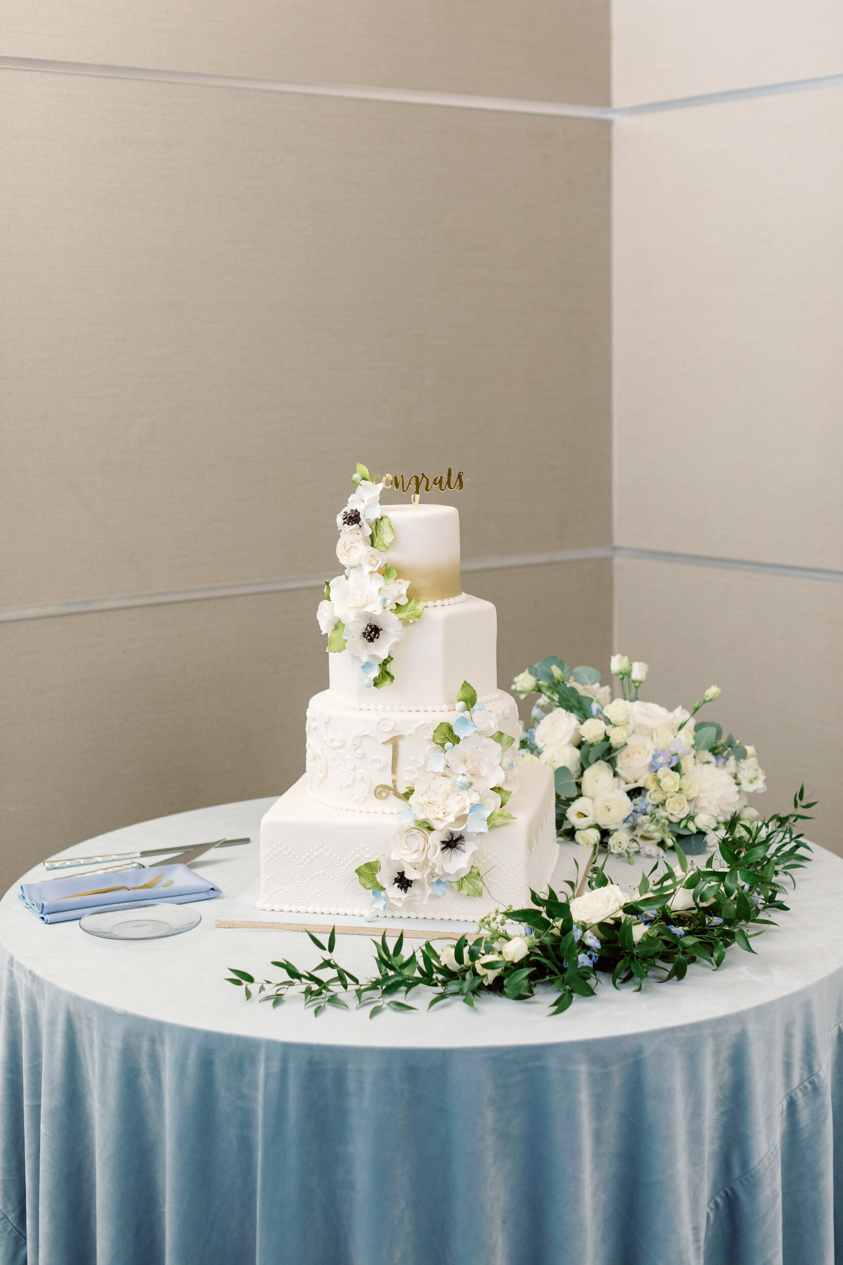 Four-tiered White Geometric Wedding Cake with Cascading Flowers