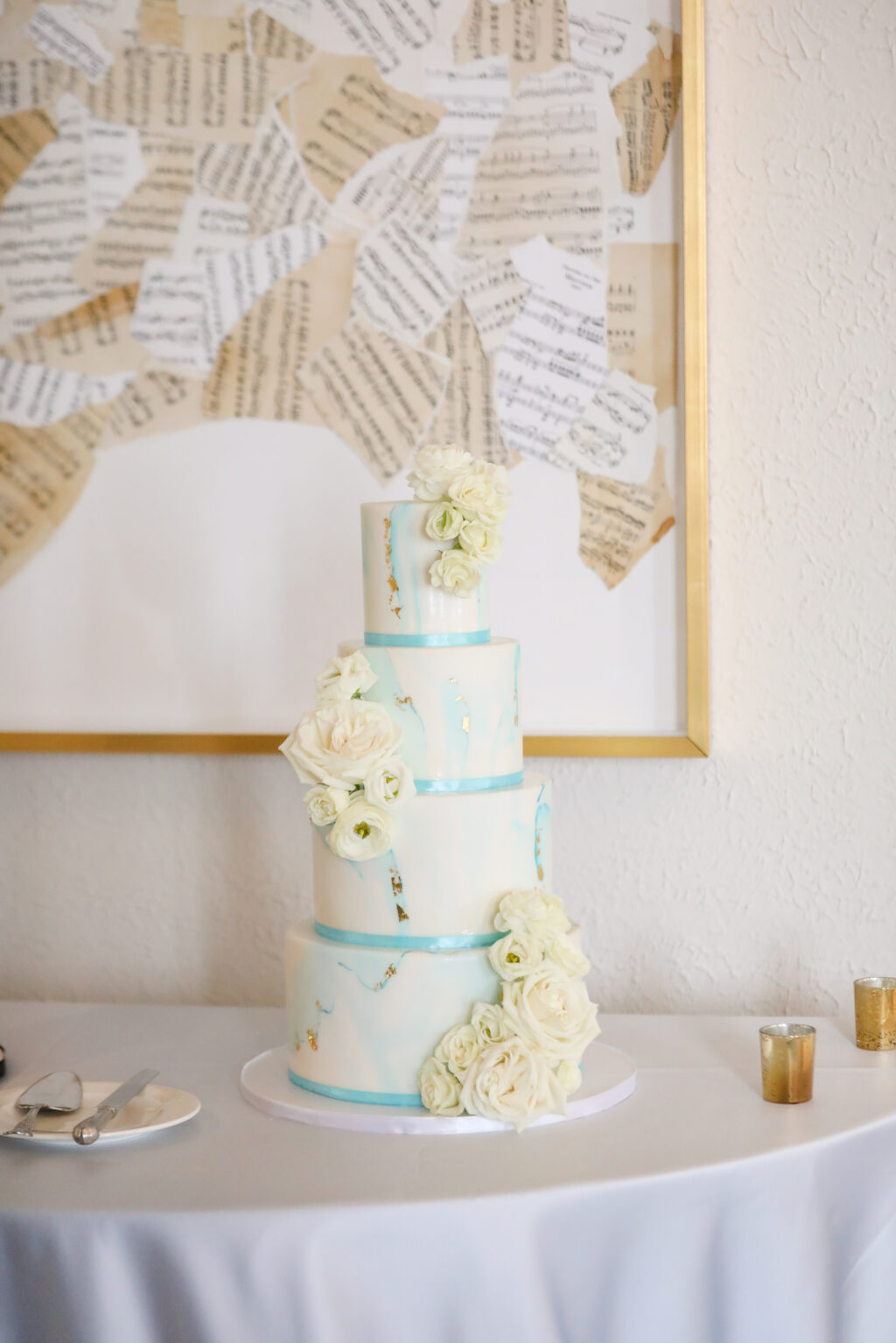 Classic Four-Tiered Sky Blue Ribbon and Marbling with Gold Foil and Real Flowers Wedding Cake | Tampa Bay Cake Company