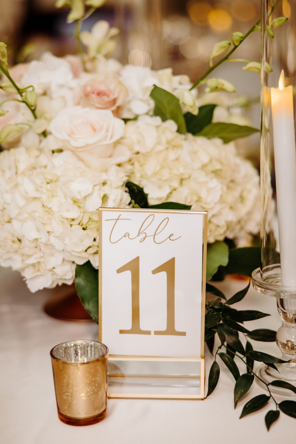 Gold Framed Table Numbers | White Hydrangea and Rose Centerpieces Inspiration | Gold Votive Candles