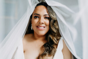 Classic Bride with Neutral Makeup and Wavy Down Hair with Veil Blowing Wedding Beauty Portrait | Tampa Bay Wedding Photographer Amber McWhorter Photography | St. Pete Wedding Hair and Makeup Femme Akoi Beauty Studio