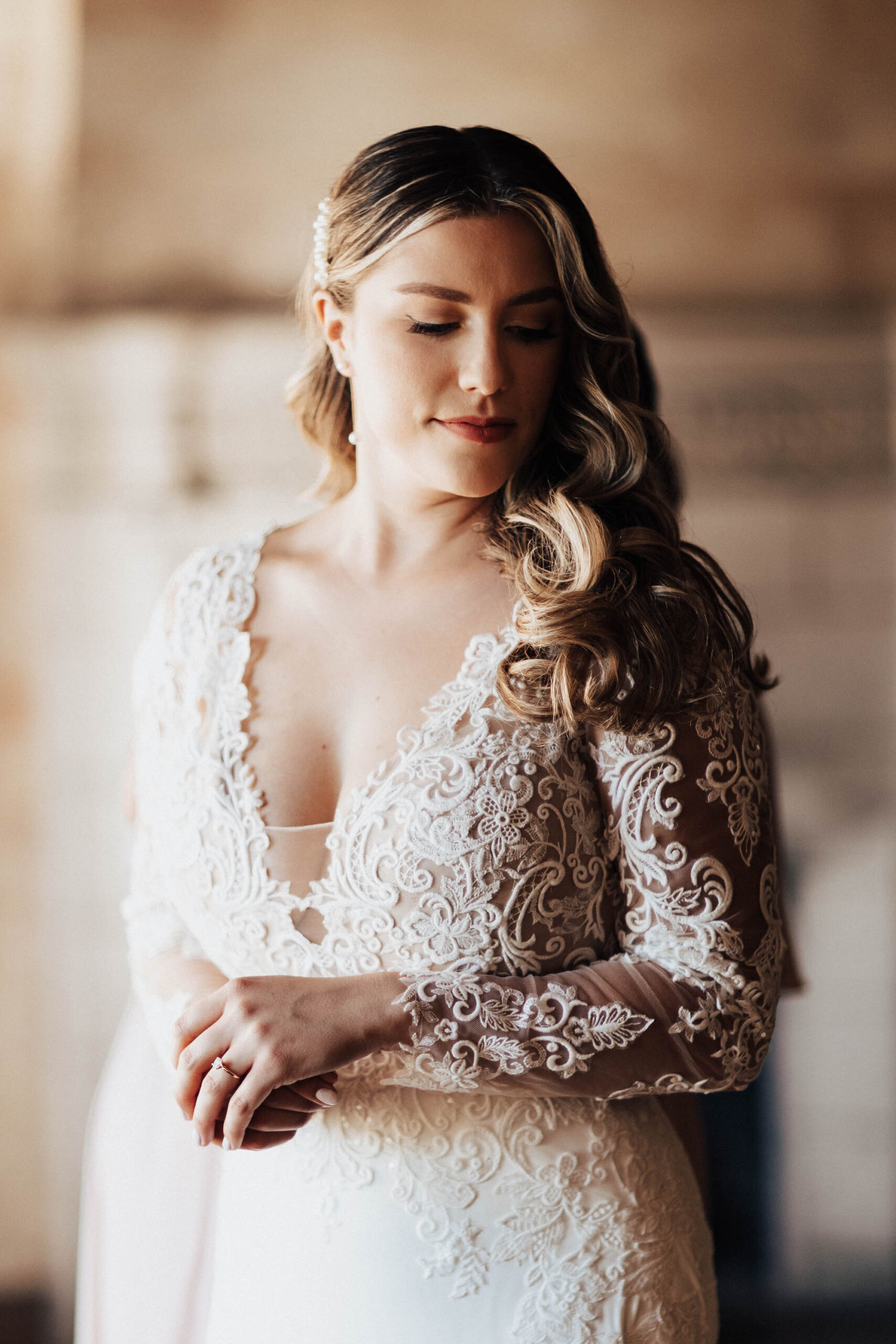 Bride with Retro Curls and Classic Makeup in Long Sleeve White Sheer Wedding Dress | Tampa Wedding Hair and Makeup Artist Femme Akoi