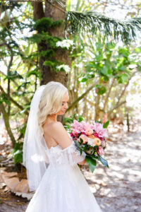 Beachy Bride with Tropical Pink Orchid, Orange Peach Ranunculus, Orange Peach Garden Rose, and Greenery Wedding Bouquet | St Pete Florist Save the Date Florida | Planner Eventfull Weddings | Hair and Makeup Artist Adore Bridal | Photographer Lifelong Photography Studio