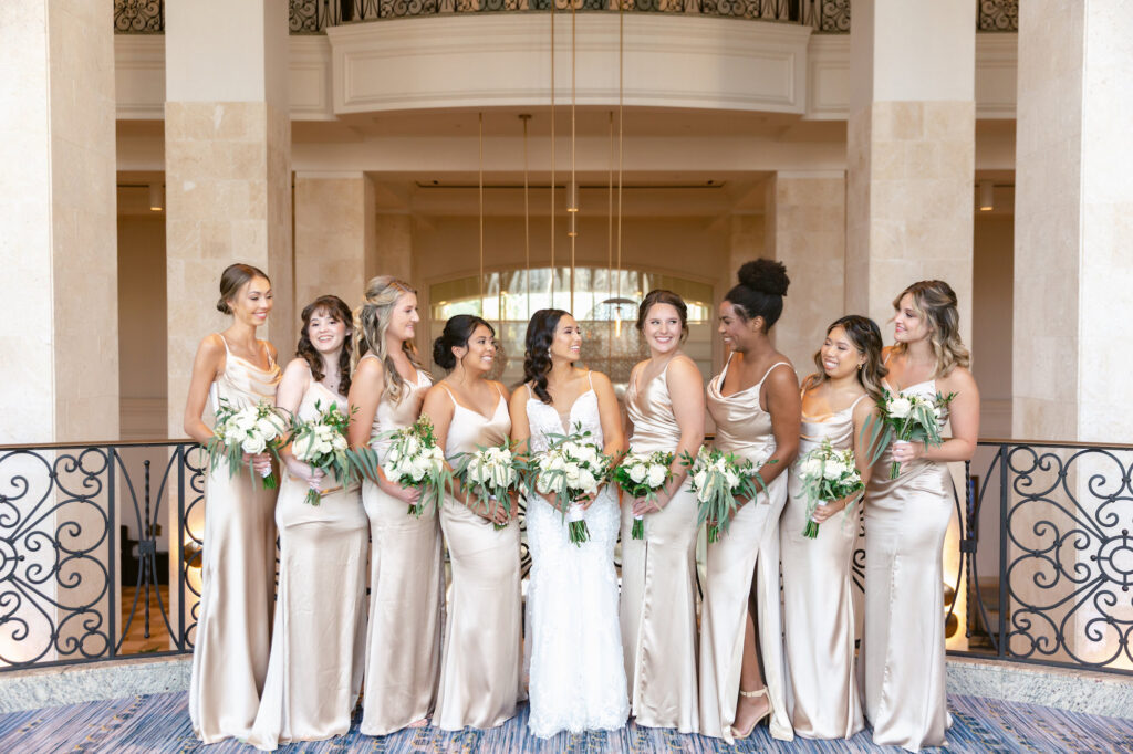 Bridesmaids in Long Neutral Champagne Revelry Satin Gowns with White and Greenery Bouquets | Tampa Wedding Hair and Makeup Artist Adore Bridal | Florist Save the Date Florida