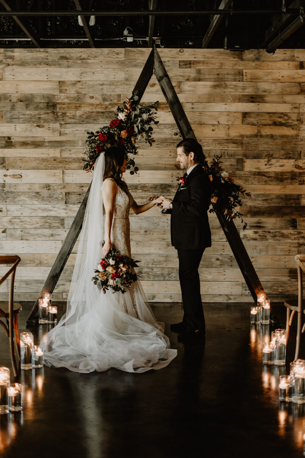 Bride and Groom Exchanging Vows | First Look Inspiration | Moody Fall Wedding Ceremony Ideas | Madeira Beach Wedding Venue The West Events | Wedding Dress Truly Forever Bridal