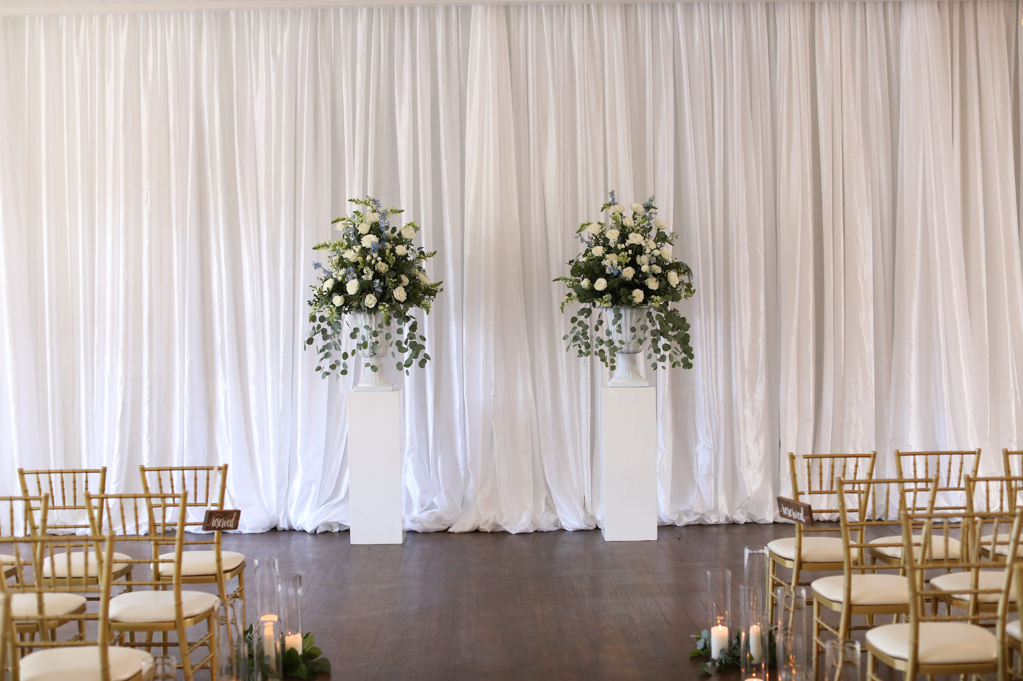 White Pillars with Roses and Blue Wildflower Altar Inspiration | Drapery Backdrop for Indoor Wedding Ceremony | Tampa Bay Venue The Orlo