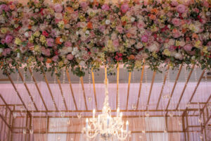 Luxurious Wedding Ceremony Altar Flowers, Blush Pink, Coral, Vibrant Yellow, Red, and Greenery with Crystal Chandelier
