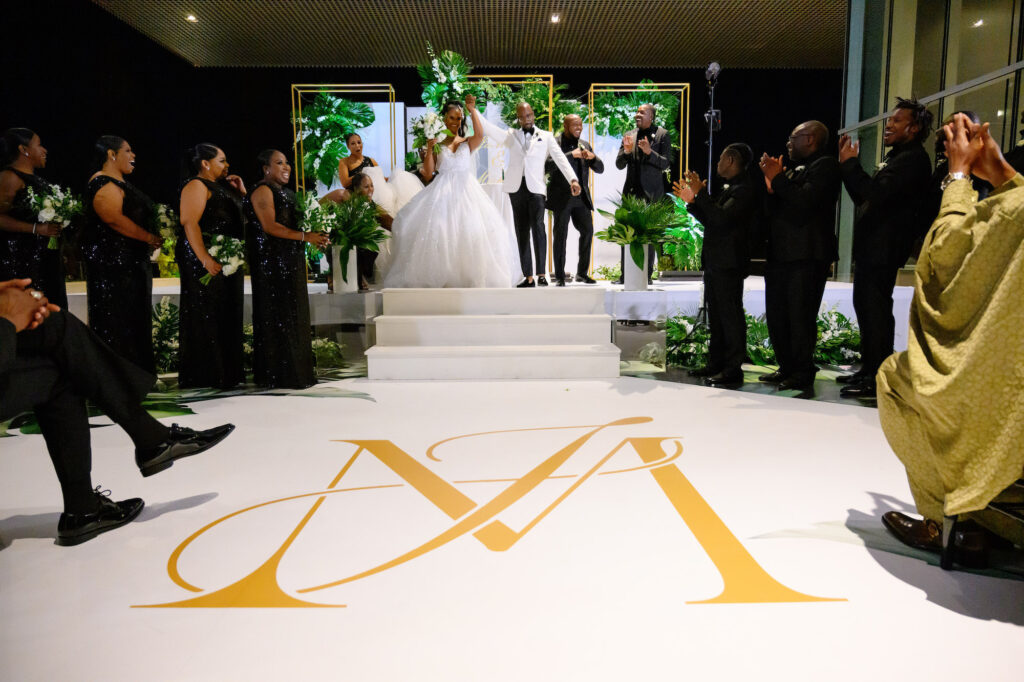 Modern White and Gold Ceremony Arch with Tropical Greenery Inspiration | White Monogram Dance Floor | Tampa Bay Florist FH Events