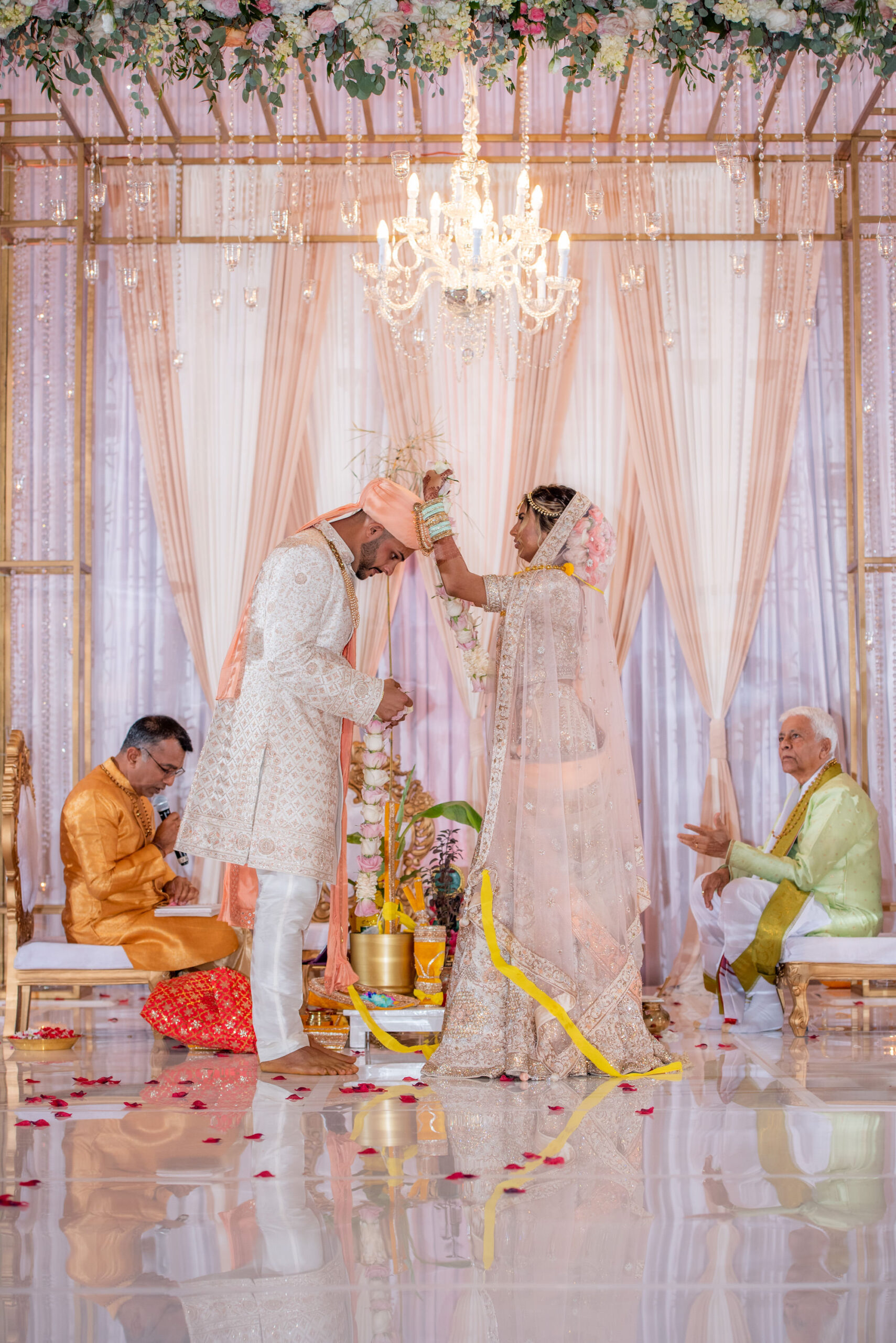 Luxurious Indian Wedding Ceremony, Bride and Groom Wearing Turban, Head Covering, Saree, Rose Gold, Blush Pink Florals with Chandelier Lighting and Draping | Florida Wedding Venue Hilton Downtown Tampa