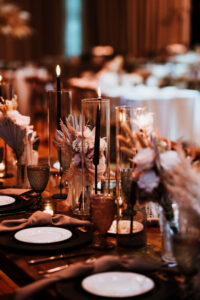 Modern Black Tapered Candles with Hurricane Glasses on Dark and Moody Tablescape Wedding Reception Inspiration