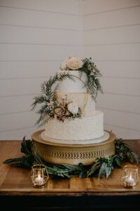 White and Champagne Three-Tiered Round Wedding Cake with Greenery Accents | Rustic Wedding Cake Inspiration