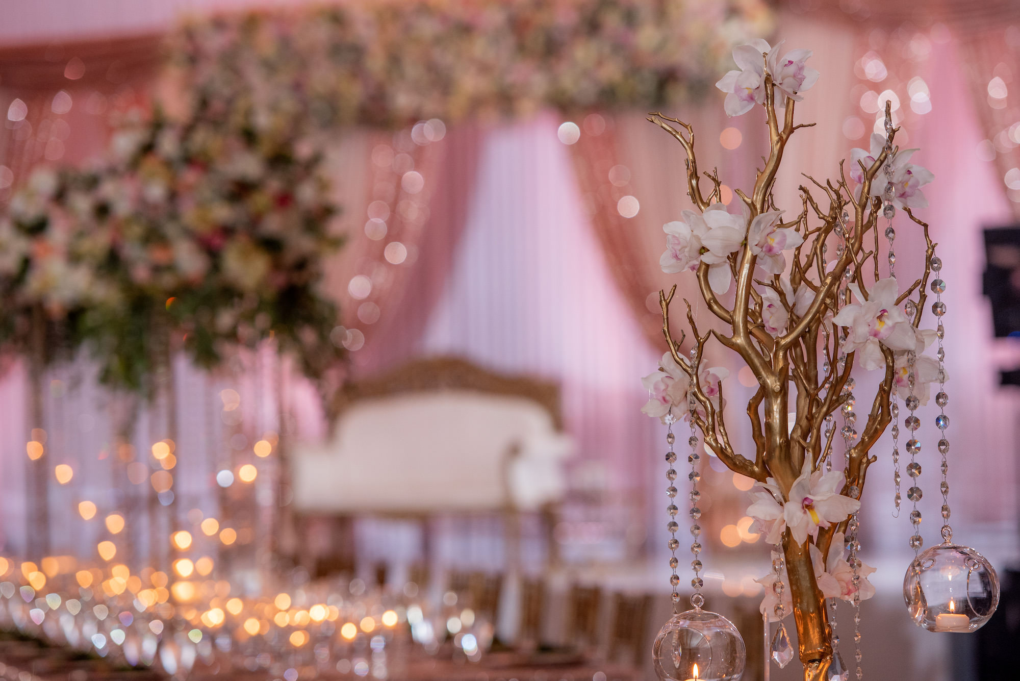 Modern Luxurious Ballroom Wedding Reception Decor, Small Floral Centerpiece with Hanging Tea Lights, Pink Flowers, White Florals, Ivory Stems, Tree Inspired Stand with Crystals, Sequined Table Linens