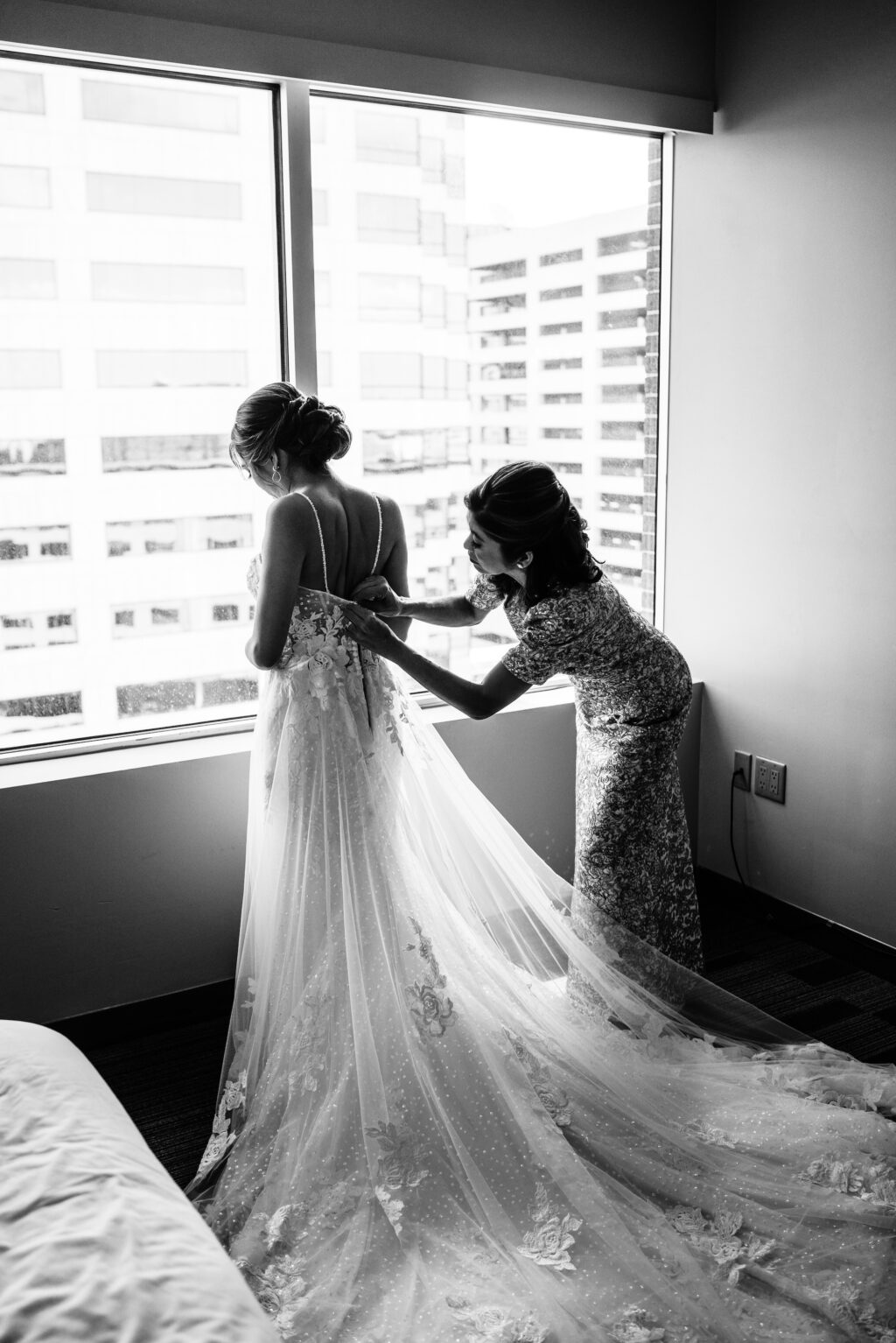 Mother of the Bride Helps Bride into Dress Black and White Wedding Portrait Inspiration
