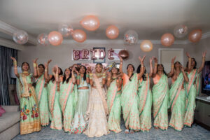 Florida Indian Bridal Party Wearing Traditional Saree Lehenga in Turquoise and Coral, BRIDE Letter Balloons