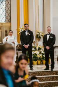 Groom Sees Bride Walking Down the Aisle for the First Time in Church Wedding Portrait