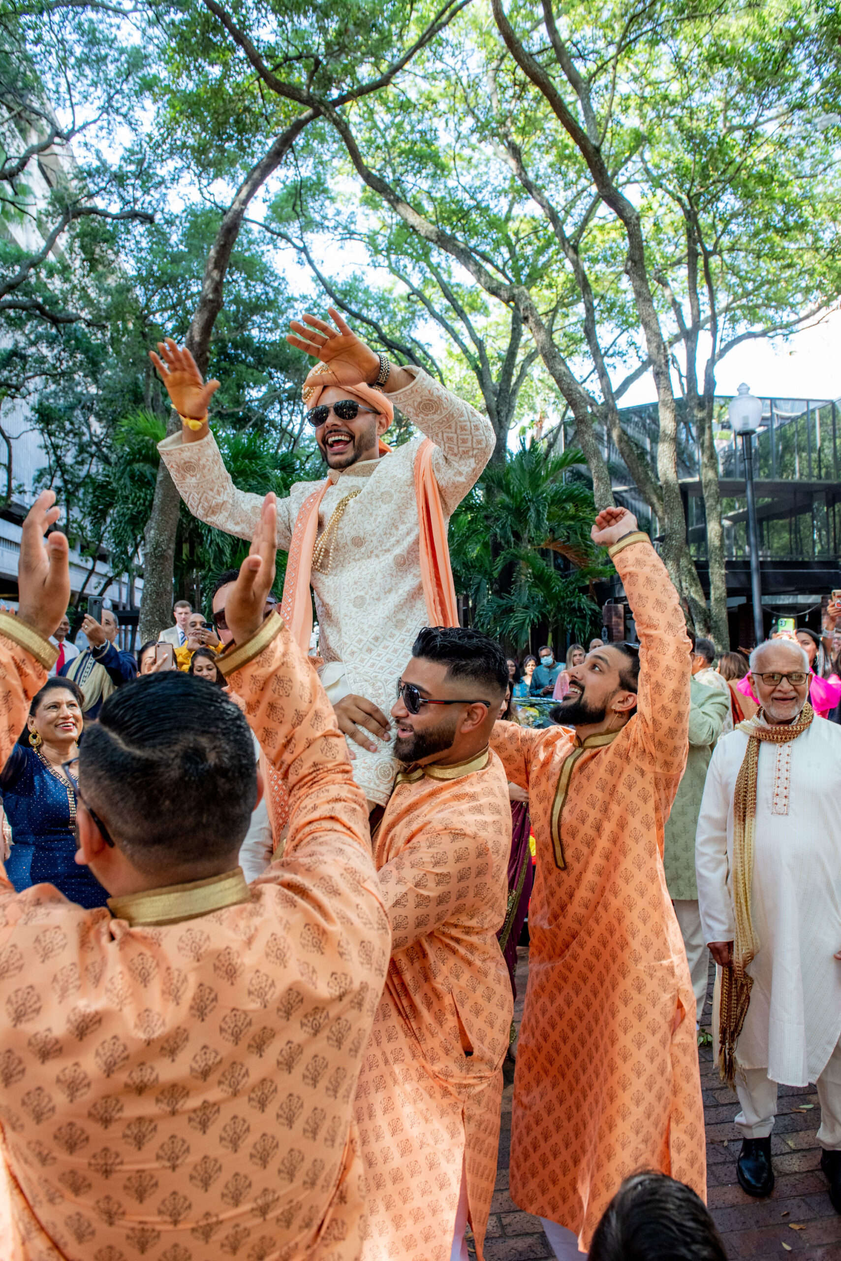 Florida Groom Baraat in Traditional Indian Wedding Entrace, Wearing Kurta in Gold, Coral |Tampa Bay Wedding Venue Hilton Downtown Tampa