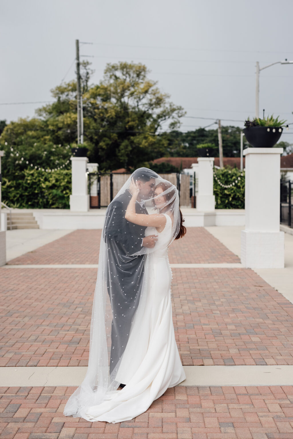 Bride and Groom Veil Portrait | Brick Courtyard Ceremony and Reception Site | Market Lights | Tampa Bay Wedding Venue Haus 820