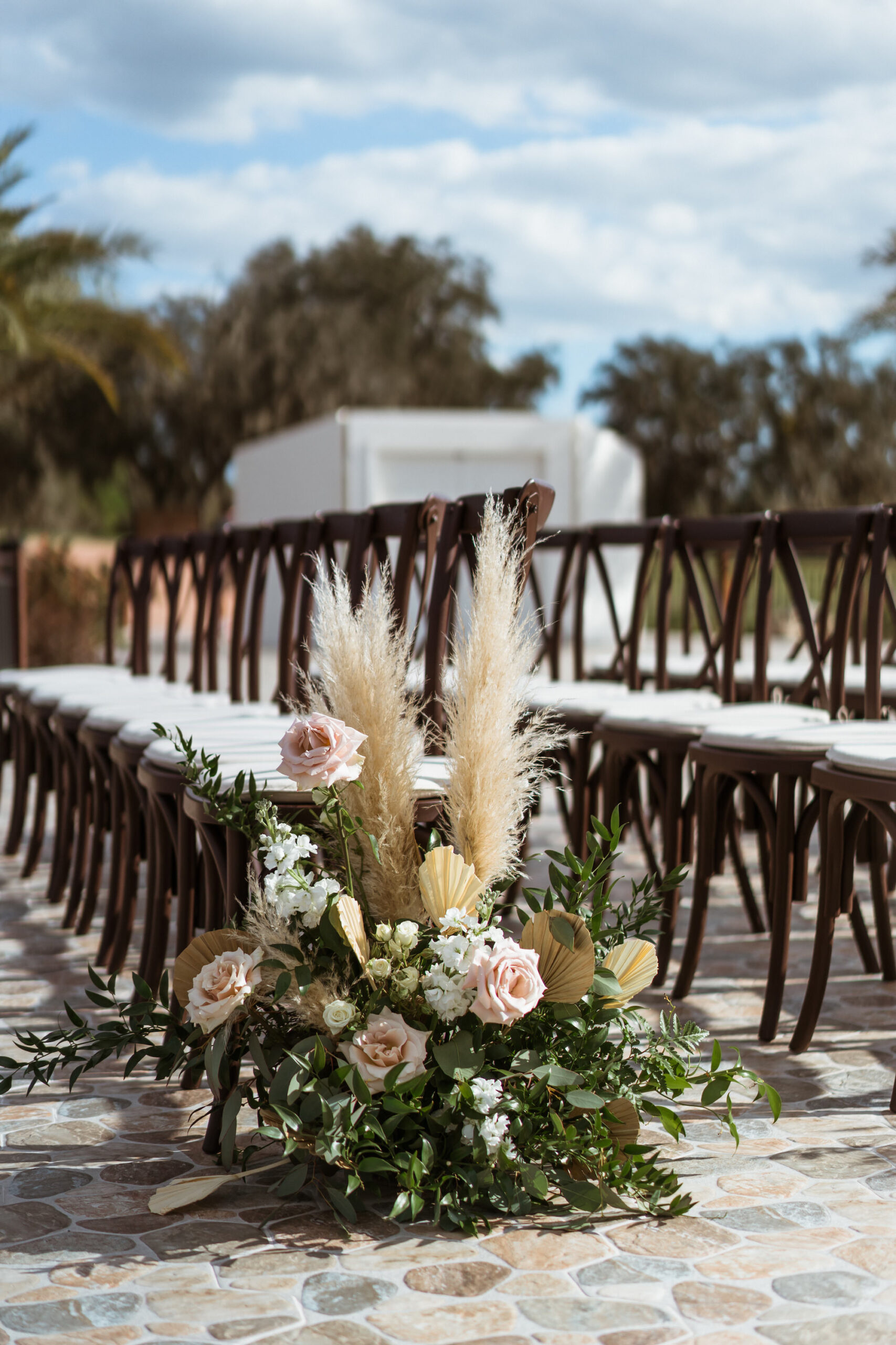 Pink Boho Wedding Ceremony Aisle Decor Inspiration | Pampas Grass, Dried Palm Leaves, Roses, and Greenery Floral Arrangements