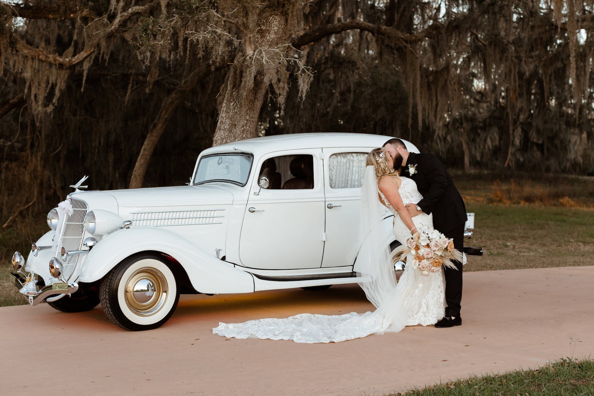Romantic Bride and Groom Kiss Wedding Portrait | Vintage Car Wedding Transportation
