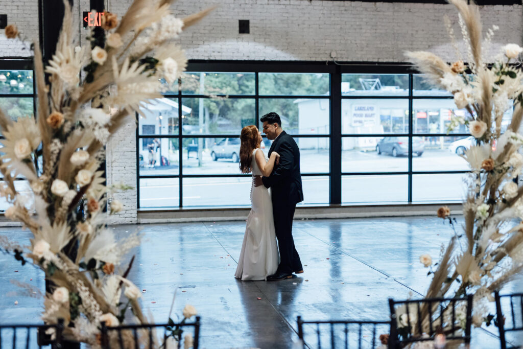 Bride and Groom First Dance Wedding Reception Portrait | Large Natural Light Windows | Lakeland Wedding Venue Haus 820