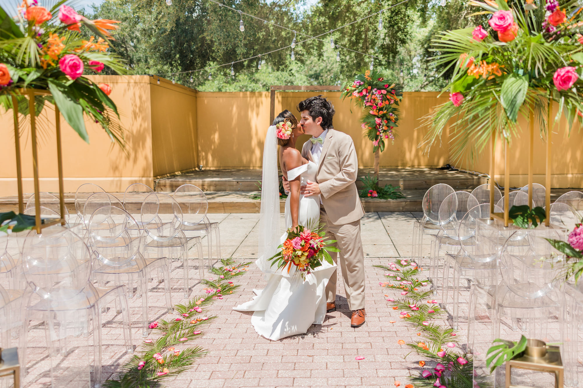 Pink and Orange Tropical Outdoor Courtyard Wedding Ceremony Ideas | Acrylic Oval Ghost Chairs | Tampa Bay Rental A Chair Affair | Wedding Venue Tampa Palms Golf & Country Club | Wedding Planner Kelci Leigh Events | Florist Save the Date Florida | Videographer Priceless Design Studio
