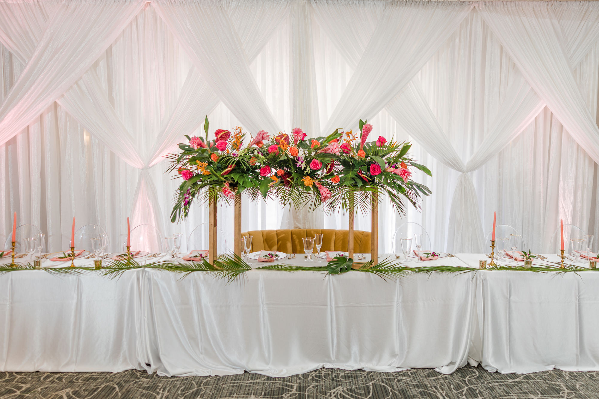 Tropical Pink and Orange Wedding Reception Inspiration with Long Feasting Head Sweetheart Table | Pink Taper Candles | Tampa Bay Florist Save the Date Florida | Planner Kelci Leigh Events