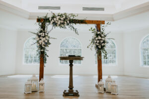 Wooden Wedding Altar Arch with Lantern and White Flowers and Greenery Floral Arrangement Ideas | Safety Habor Harborside Chapel Wedding Venue