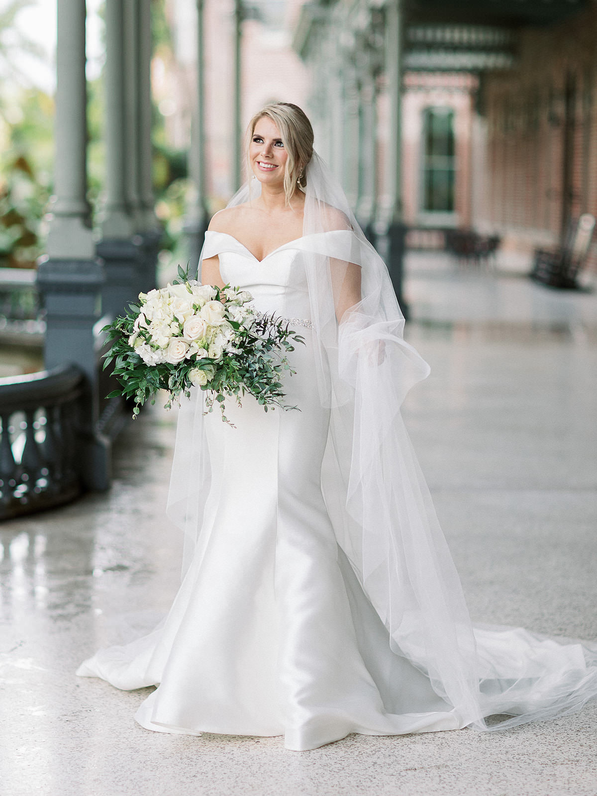White Rose and Ruscus Greenery Bridal Bouquet | Elegant White Ivory Satin Off the Shoulder Fit and Flare Maggie Sottero Wedding Dress | Cathedral Length Veil