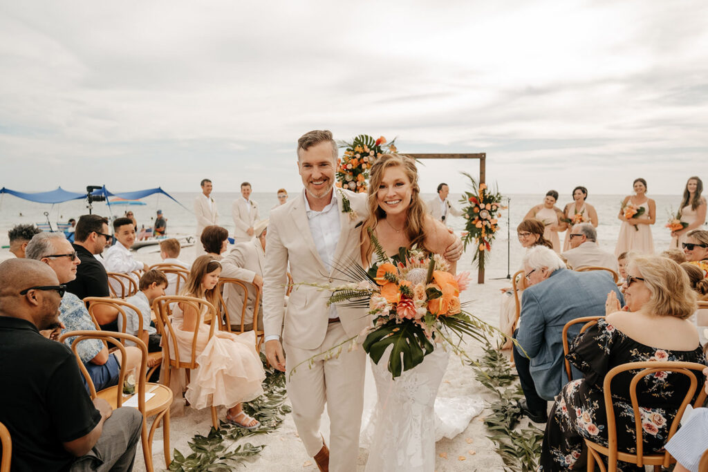 Bride and Groom Walking Down Tropical Beach Wedding Aisle