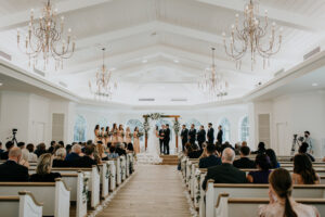 White Wedding Chapel With Vintage Chandelier Lighting | Tampa Bay Harborside Chapel Venue