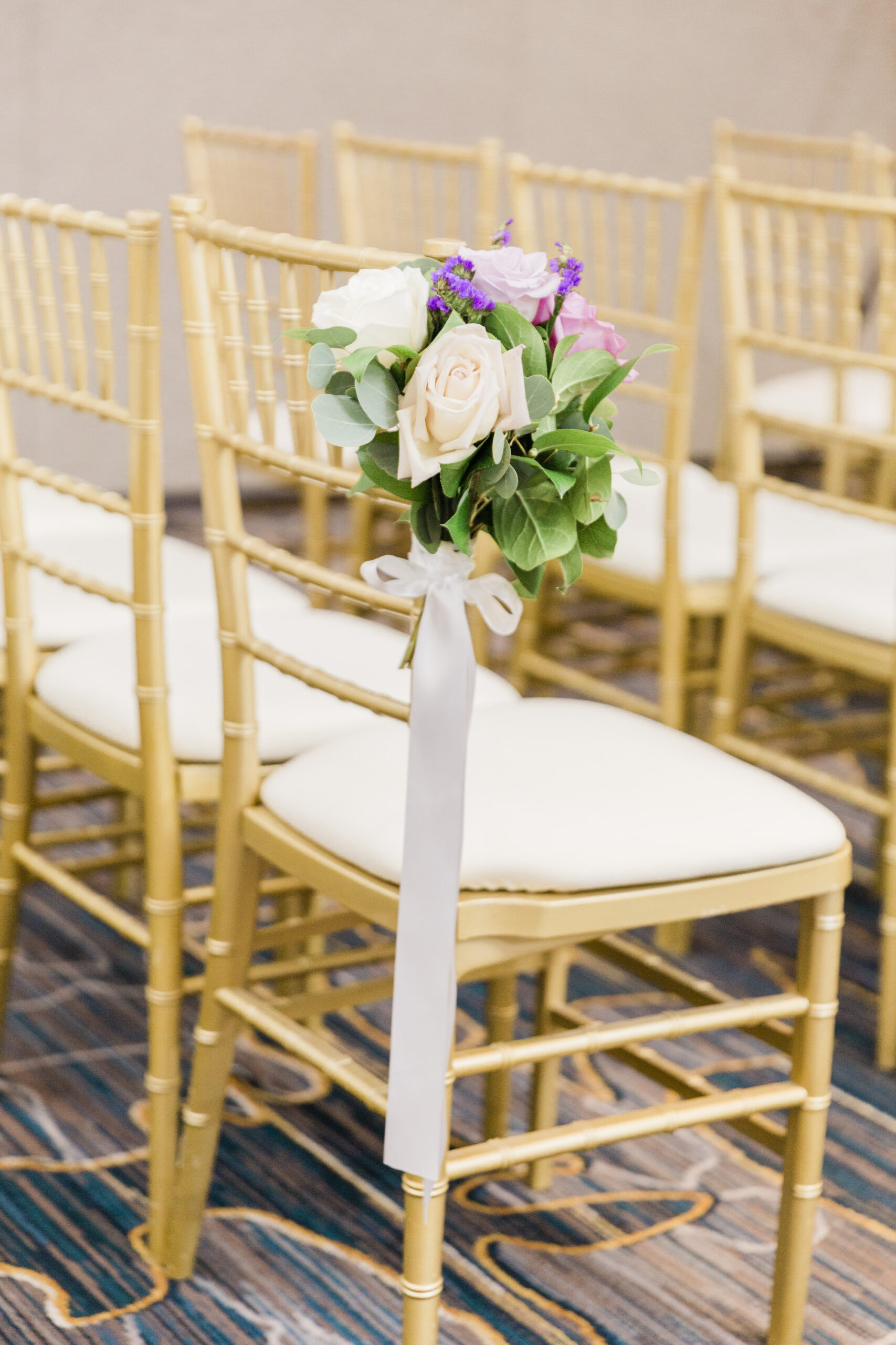 Gold Chiavari Chairs | Wedding Ceremony Aisle with White, Pink, and Purple Flower Arrangement