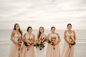 Mismatching Peach Bridesmaids Dresses | Tropical Wedding Bouquets with Anthurium, Fern, and Monstera | Anna Maria Island Florist Save the Date Florida