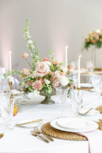 Roses, Carnations, and White Stock Flower Centerpiece Ideas | Peach and Blush Pink Boho Summer Wedding Reception Inspiration | Hyacinth Placemats with Gold Flatware | Tampa Bay Kate Ryan Event Rentals