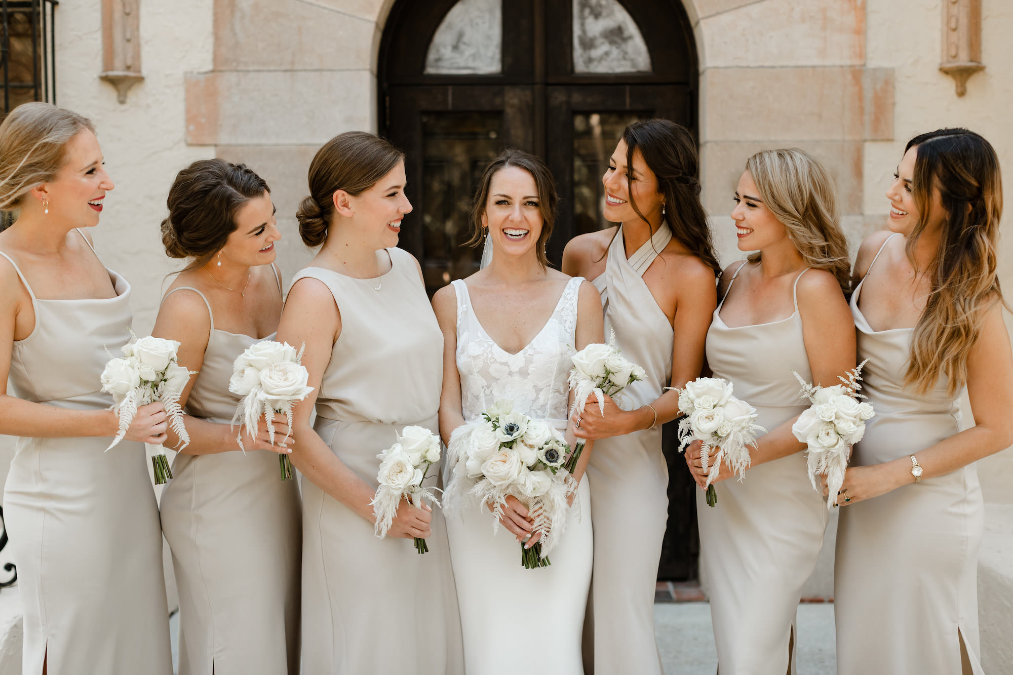 Bridal Party Wedding Portrait | Neutral Champagne Satin Mismatched Bridesmaids Gowns | White Fern, Feathers, and Rose Bouquet Inspiration | Sarasota Bride and Groom Window Portrait | Historic Sarasota Wedding Venue Powel Crosley Estate | Photographer Garry and Stacy Photography Co.