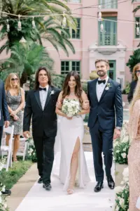 Bride Walks Down the Aisle with Father of the Bride and Brother in Outdoor Wedding Ceremony