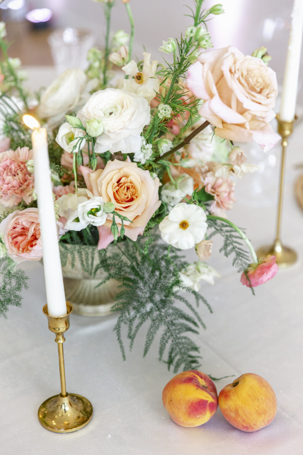 Taper Candles With Gold Candle Holders | Peach Roses, Pink Garden Roses, Carnations, and White Philadelphius, Ferns, and Stock Flowers Spring Wedding Reception Centerpiece Ideas