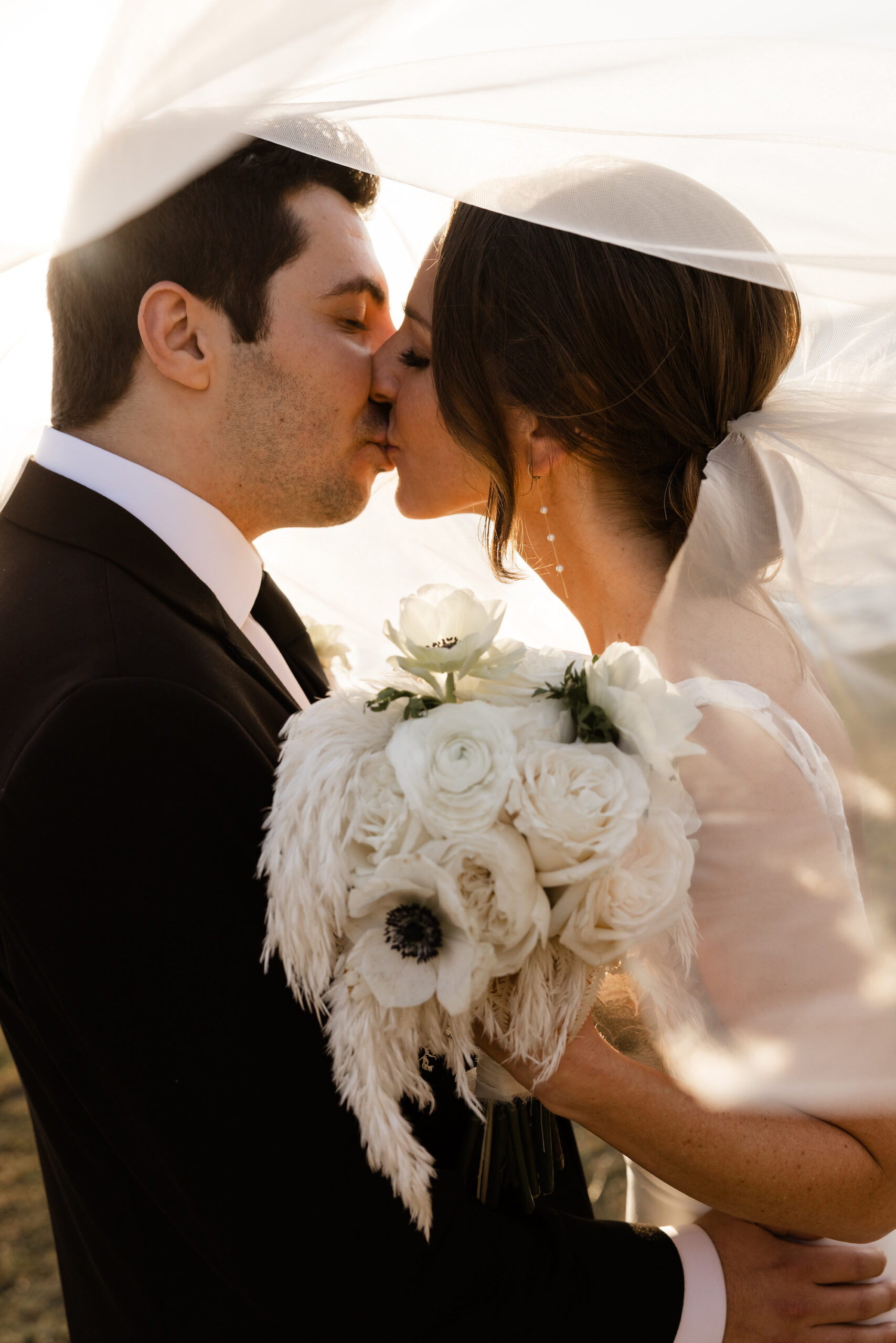 Classic Bridal Bouquet with White Feathers, Garden Roses, and Anemone | Romantic Bride and Groom Veil Portrait | Sarasota Wedding Photographer Garry and Stacy Photography Co.