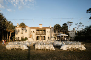 Sunset Outdoor Lawn Wedding Reception | Market lights | Gold Chiavari Chairs | Sarasota Venue Powel Crosley Estate