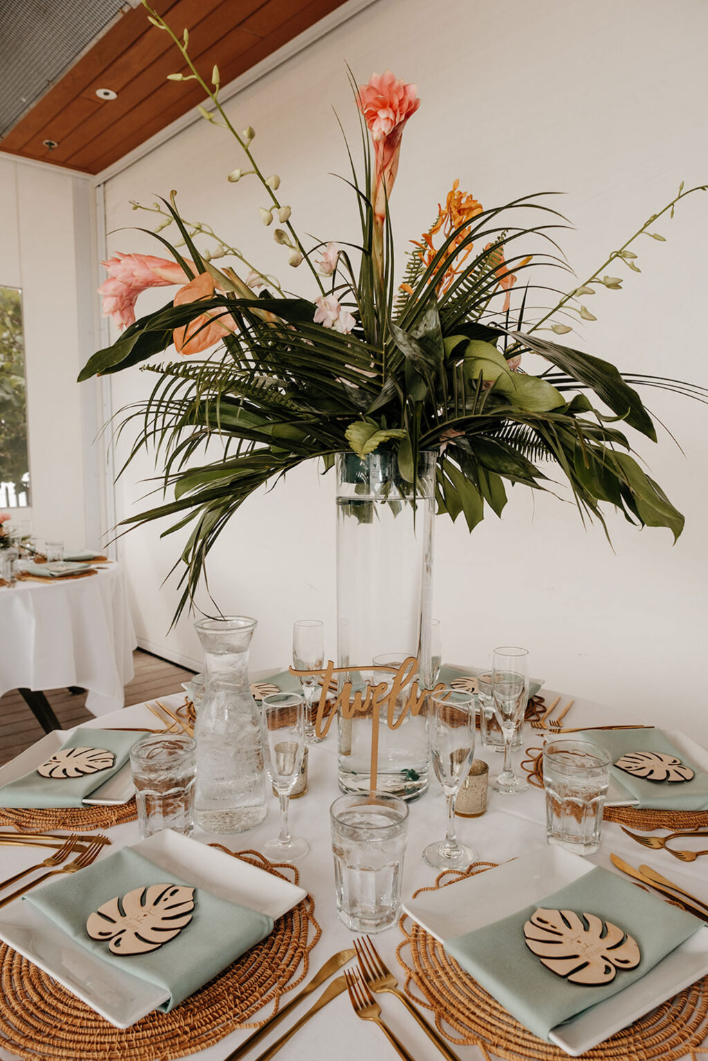 Tall Glass Vase Tropical Orange Torch Ginger, Monstera, and Palm Table Wedding Reception Centerpieces | Sarasota Florist Save the Date Florida
