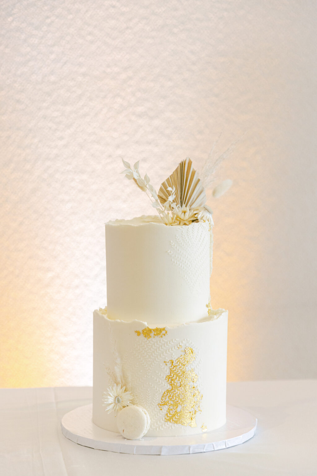 White Two-tier Textured Boho Round Wedding Cake with Dried Flower Accents, Macarons and Gold Foil Ideas