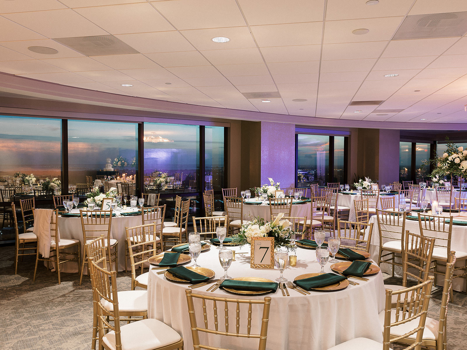 Canopy Ballroom Classic Evening Wedding Reception Decor Inspiration | Green Linen and Gold Chargers | Gold Frame Table Number | Gold Chiavari Chairs | Downtown Venue The Tampa Club | Over The Top Linen Rentals