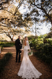 Bride and Groom Wedding Portrait | Long Sleeve White Ivory Blush Sheer Lace Fit and Flare Wedding Dress with Cathedral Train | Tampa Bay Venue Cross Creek Ranch