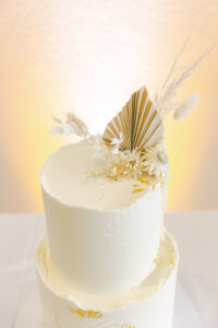 White Two-tier Round Textured Boho Wedding Cake with Dried Flower Accents, Macarons and Gold Foil Inspiration