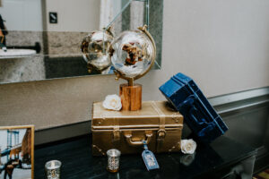 Travel Themed Wedding Ideas | Gold Suitcase and Globe Decor Inspiration