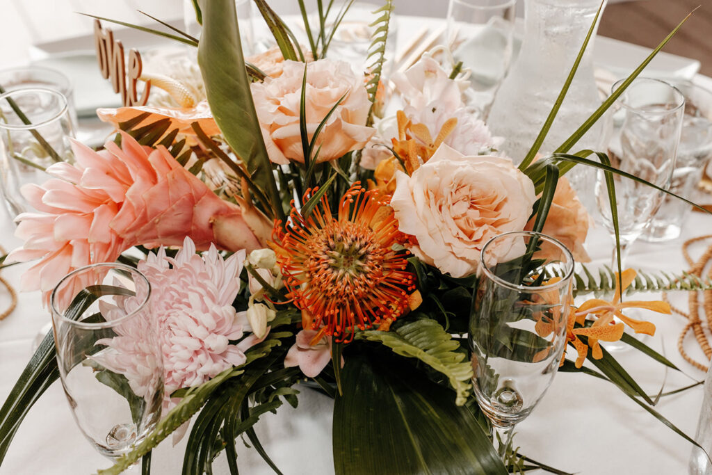 Tropical Centerpieces | Fern, Orange Pin Cushion Protea, Pink Chrysanthemum, Peach Garden Roses | Acrylic Table Number Ideas | Tampa Bay Florist Save the Date Florida