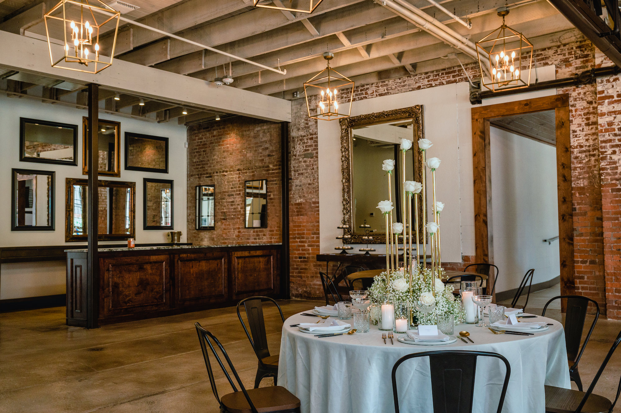 Rustic Indoor Industrial Wedding Reception | Tall Gold and White Rose Centerpiece Inspiration | Tampa Bay Florist Save The Date Florida | Venue at the Block