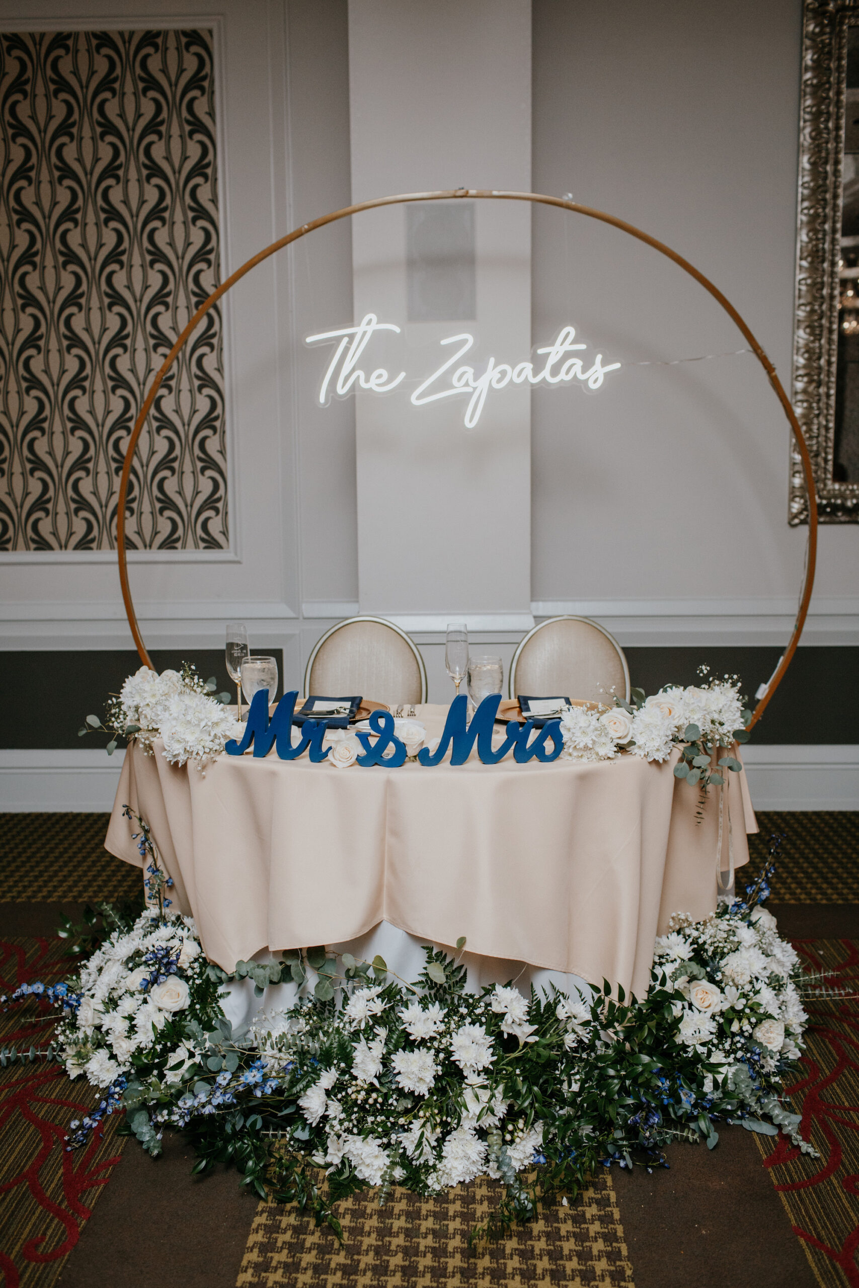 Blue and White Sweetheart Head Table Inspiration with Gold Metal Round Hoop and Custom Last Name Neon Sign